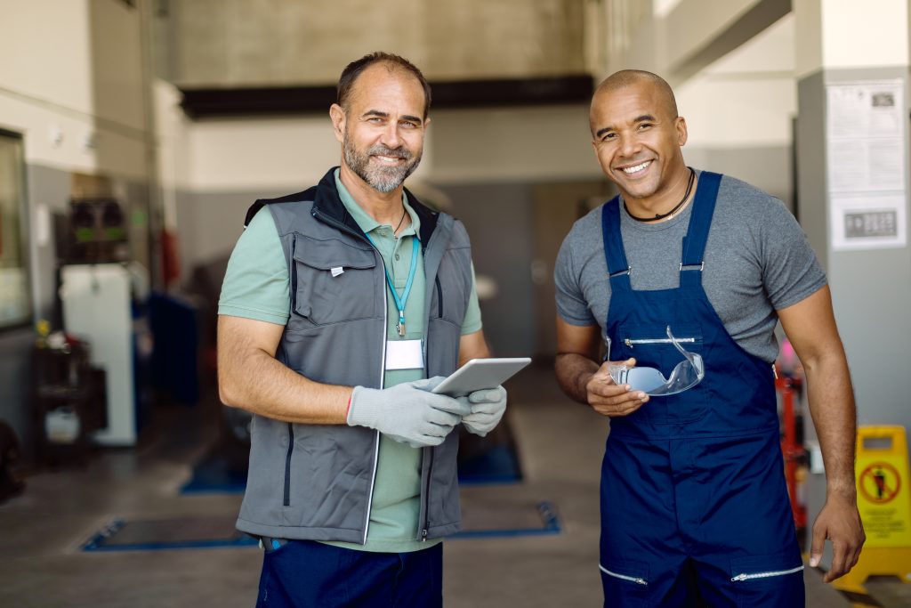 two men smiling in garage